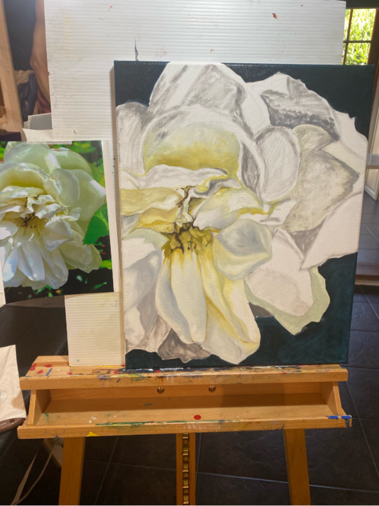 Progress painting of a flower on a canvas